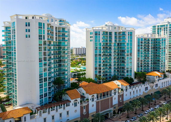 Front view of multiple high-rise residential buildings with glass balconies.