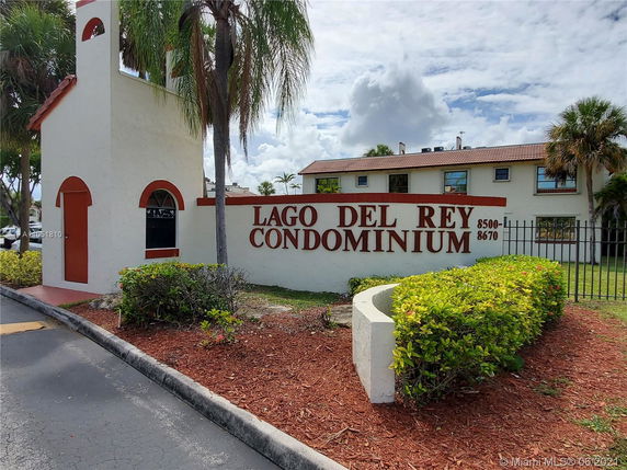 Front view of a condominium building with exterior sign.