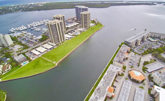 Aerial view of a waterfront area with multiple high-rise buildings and a marina.