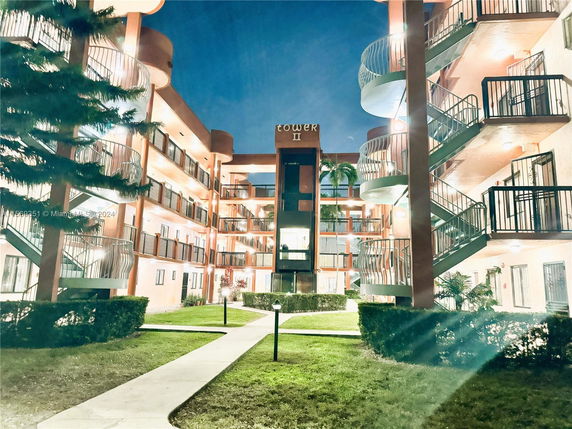 Front view of a multi-story building named Tower II with exterior staircases.