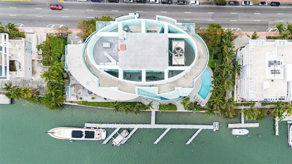 Aerial view of a building rooftop with mechanical equipment and a circular architectural design.