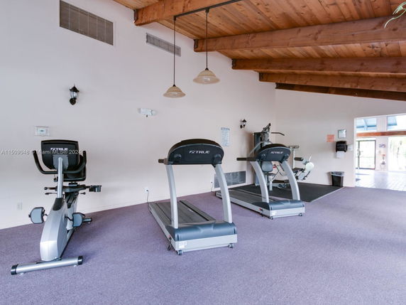 Indoor gym area with exercise equipment.