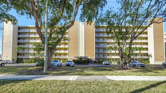 Front view of a multi-story residential building with balconies.