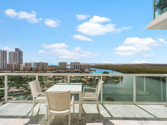Panoramic view from a balcony overlooking a cityscape and waterways.