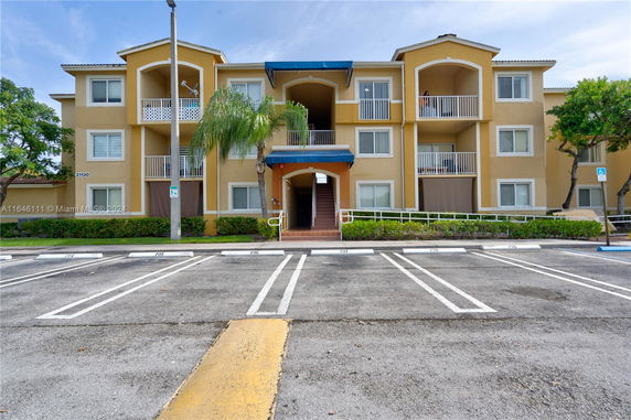 Front view of a multi-story residential building with balconies.