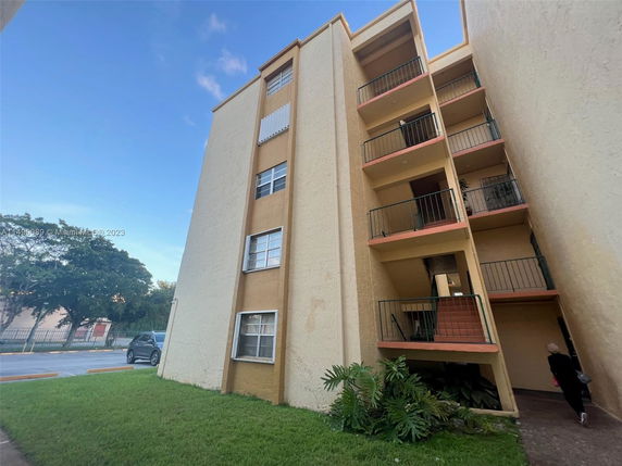Front view of a multi-story residential building with balconies.