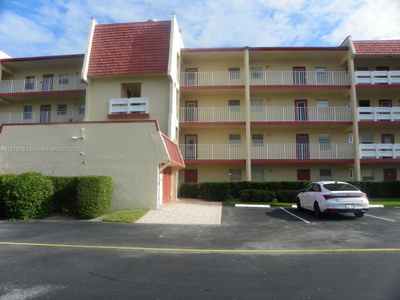 Front view of a multi-story residential building with balconies.