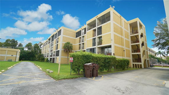 Front view of a multi-story apartment building with exterior staircases.