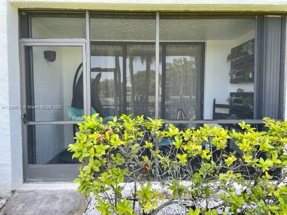 Front view of a house with a glass-enclosed patio.