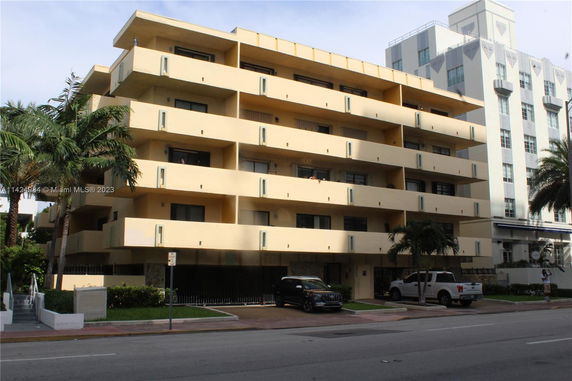 Front view of a multi-story residential building with balconies.