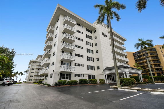 Front view of a multi-story residential building with balconies.