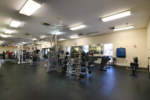 Interior view of a gym with various exercise equipment.