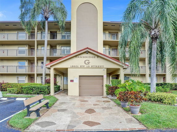 Front view of a multi-story apartment building with balconies.
