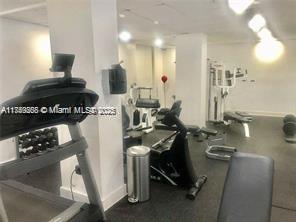 Indoor gym area with various exercise equipment including treadmills and weight machines.