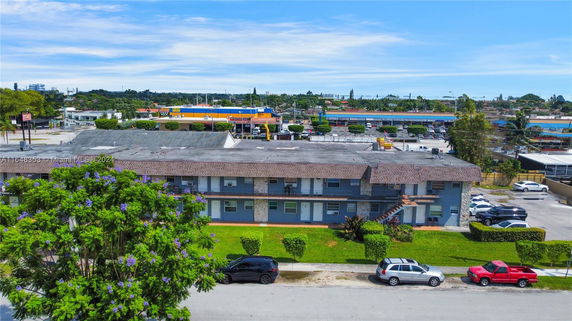 Front view of a two-story residential building with a flat roof.