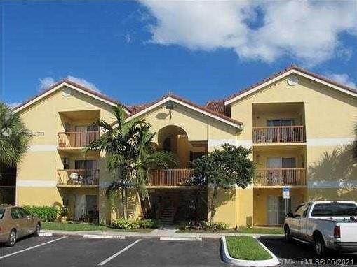 Front view of a three-story apartment building with balconies.