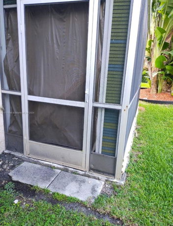 Side view of a screened exterior porch or patio area.