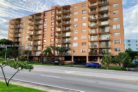 Front view of a multi-story apartment building with multiple balconies.