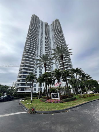 Front view of a high-rise residential building with balconies.
