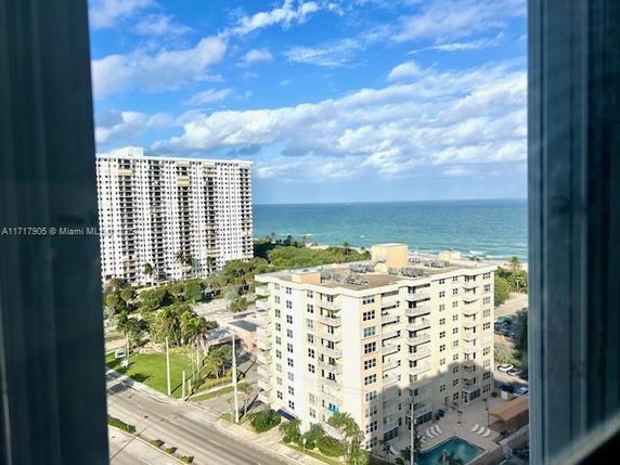 View of surrounding areas including high-rise buildings and ocean.