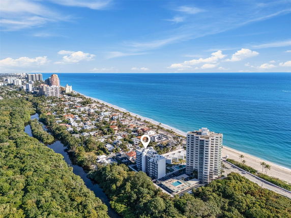 Panoramic view of coastal area with high-rise buildings and beach.