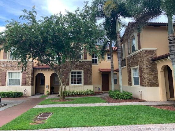 Front view of a two-story house with stone and stucco exterior.