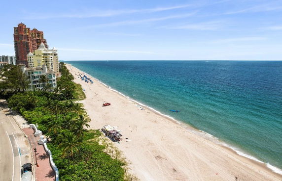 Panoramic view of a beachfront area with buildings and ocean.