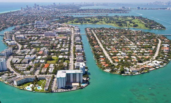 Aerial view of urban and residential areas surrounded by water.
