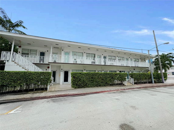 Front view of a two-story building with exterior staircases.