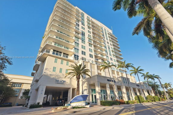 Front view of a multi-story building with balconies.