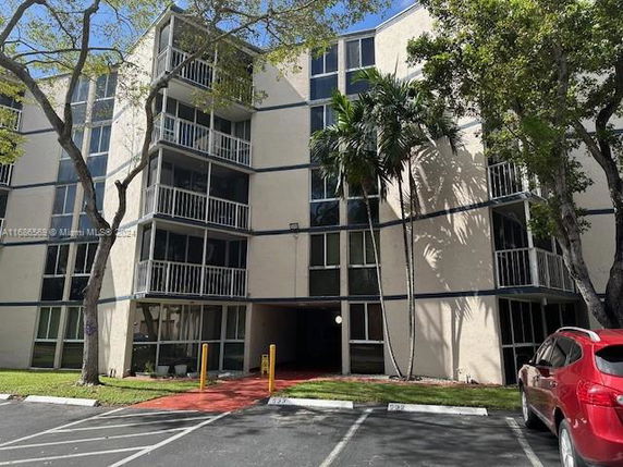 Front view of a multi-story residential building with balconies.