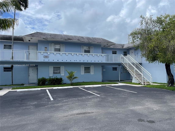Front view of a two-story building with a staircase leading to the upper level.
