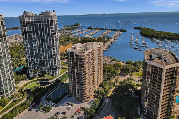 Aerial view of high-rise residential buildings near a marina.