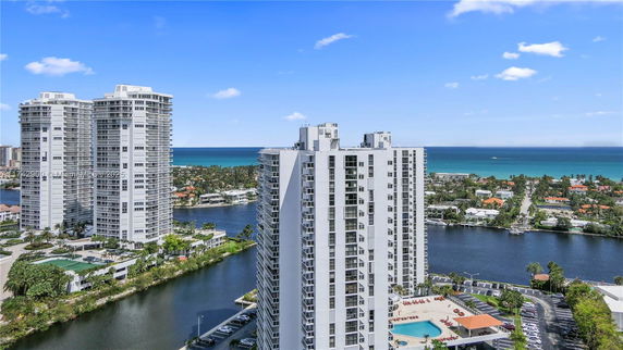 High-rise buildings with a view of the ocean and surrounding residential area.