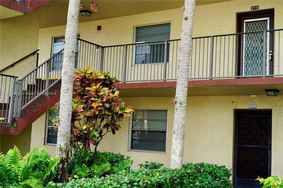 Exterior view of a two-story building with stairs and balconies.