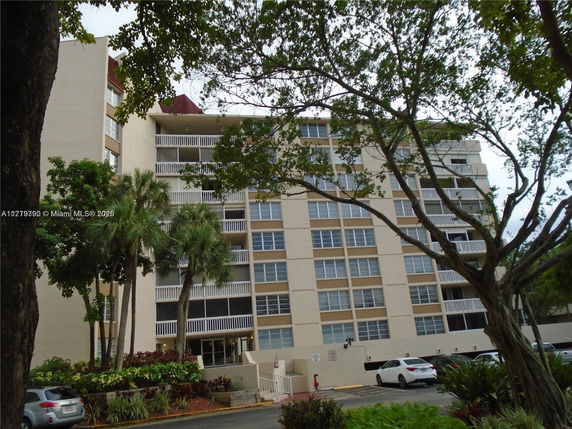 Front view of a multi-story residential building with balconies.