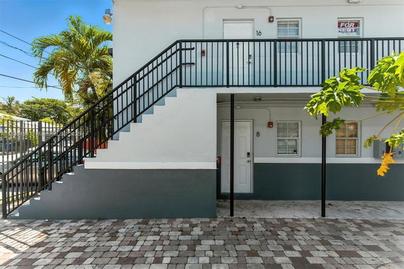 Front view of a two-story building with external staircase