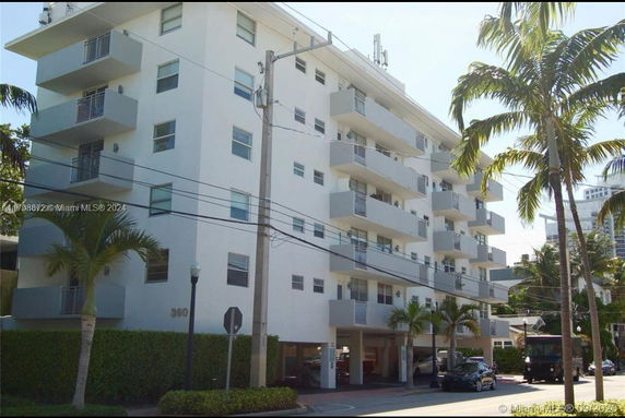 Front view of a multi-story residential building with balconies.