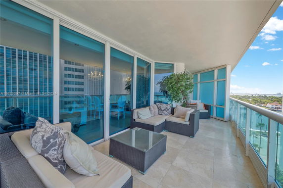 Outdoor patio with glass railings and city view.