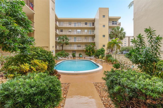 Swimming pool with surrounding apartment buildings.