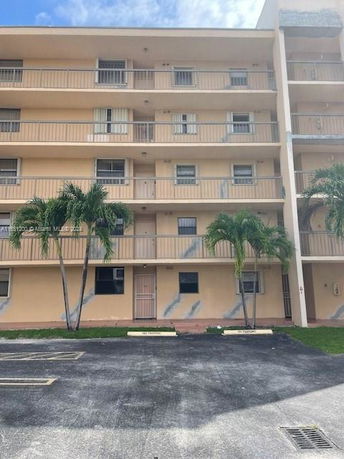 Front view of a multi-story residential building with balconies.