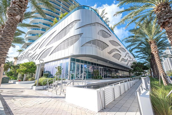 Front view of a modern multi-story building with a unique facade design.