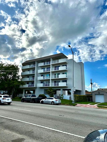 Front view of a multi-story residential building with balconies.