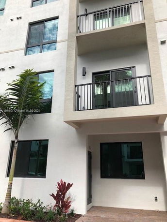 Front view of a multi-story building with balconies.