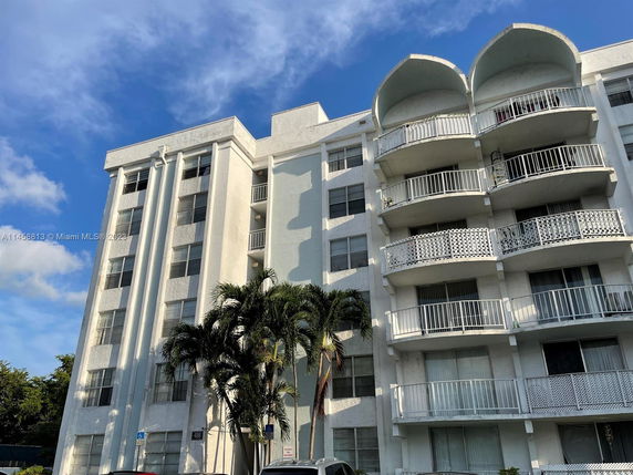 Front view of a multi-story residential building with balconies.