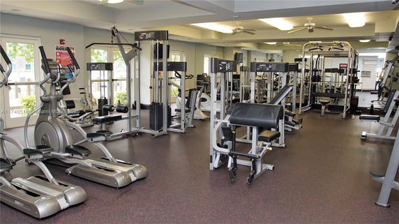 Interior view of a gym with exercise equipment and machines.