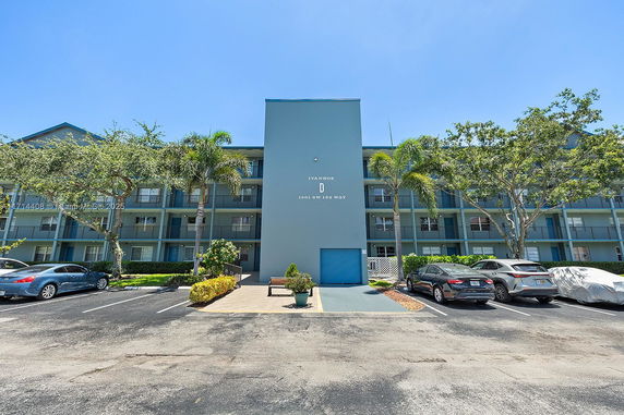 Front view of a multi-story residential building with balconies.
