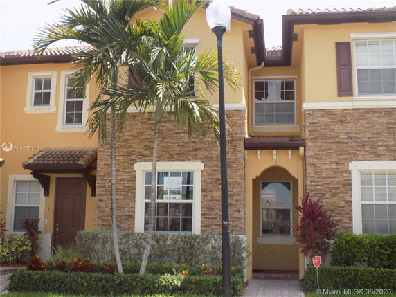 Front view of a two-story townhouse with stone and stucco exterior.