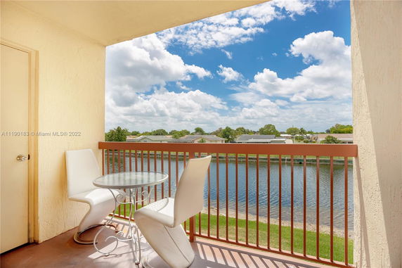 Balcony view overlooking a lake and residential area.