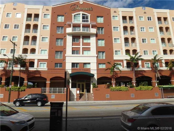 Front view of a multi-story building with balconies.